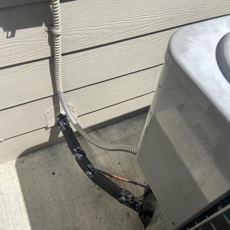 Air conditioning condenser refrigerant line with insulation wrap