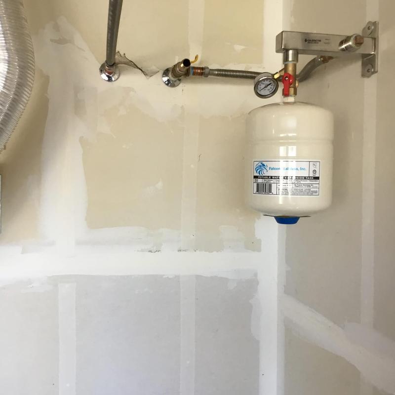 Expansion tank with pressure gauge and plumbing connections