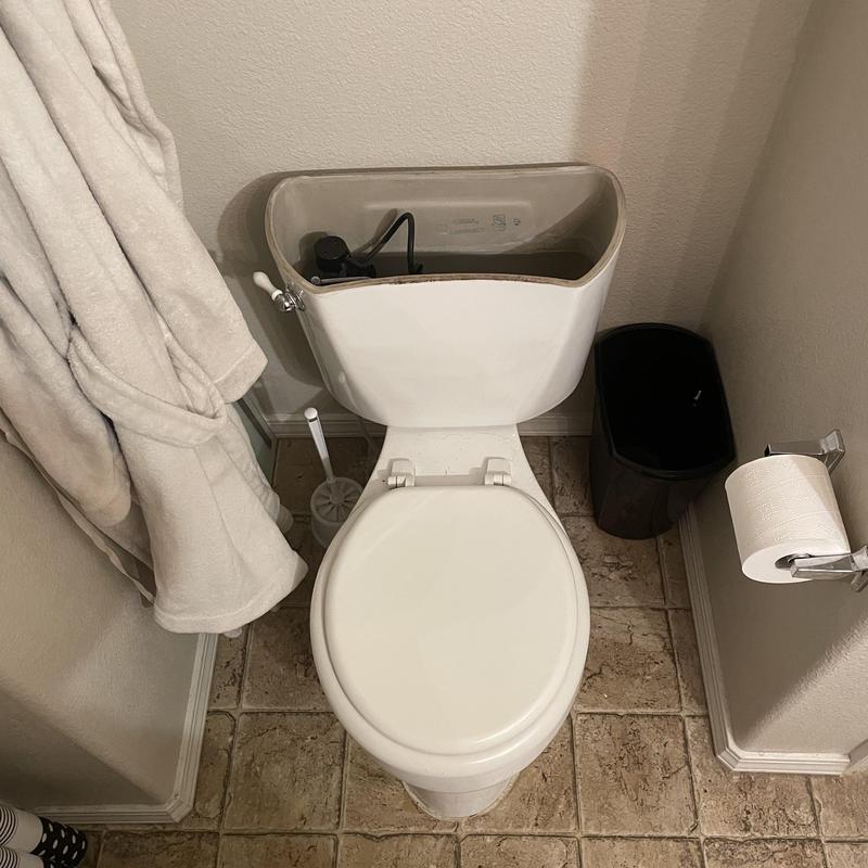Toilet tank repair and part replacement in bathroom