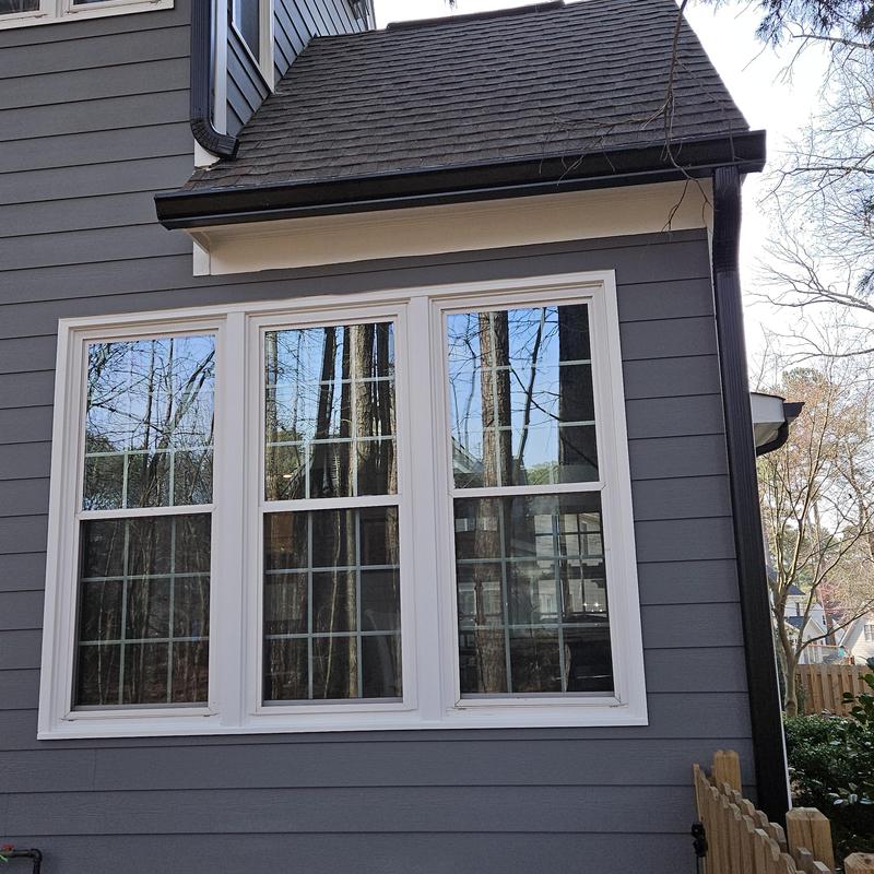 Vinyl window installation with gray siding panels