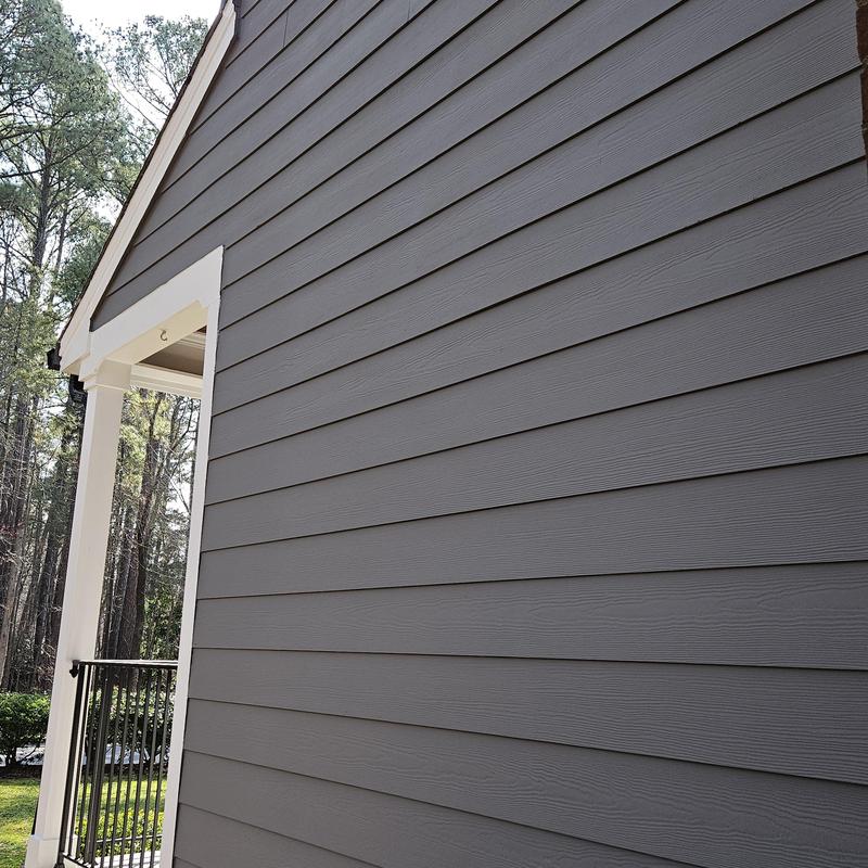 Gray fiber cement siding on house exterior wall