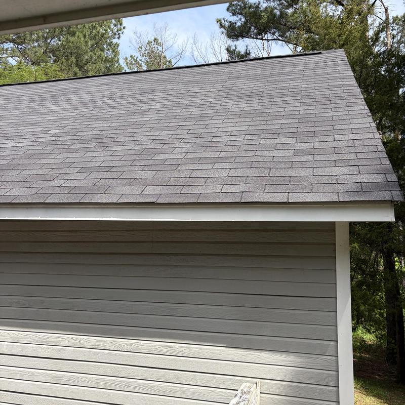 Asphalt shingle roof with replaced missing shingles