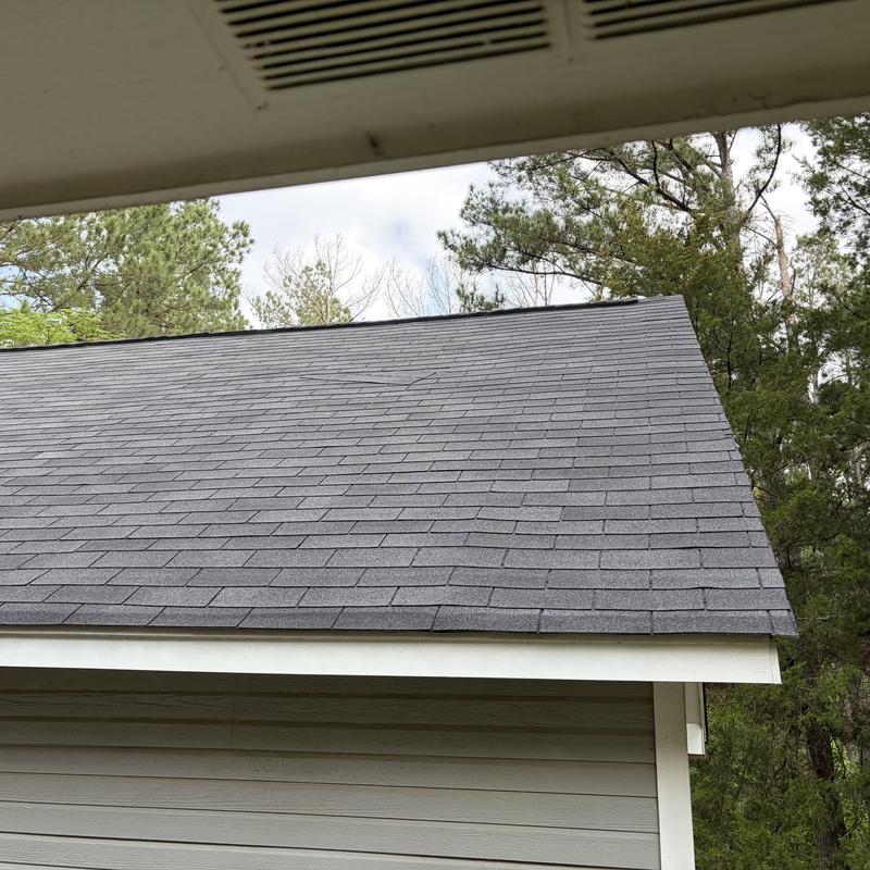 Asphalt shingle roof with replaced missing shingles