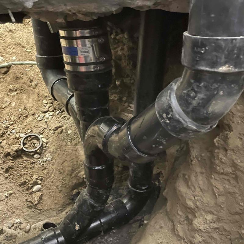 ABS pipe plumbing installation in floor cavity
