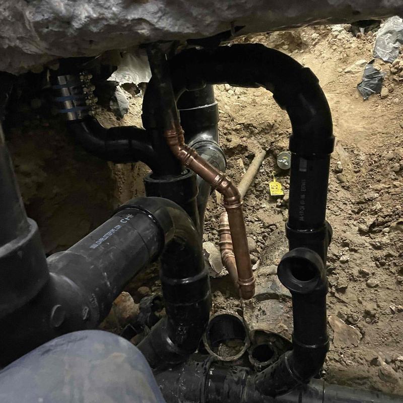 Black ABS drain pipes and copper re-pipe under floor