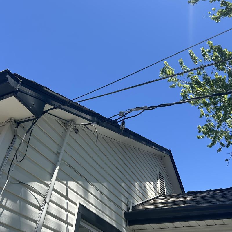 Electrical service wires attached to house under clear sky