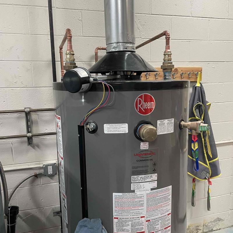 Commercial gas water heater with vent piping installation