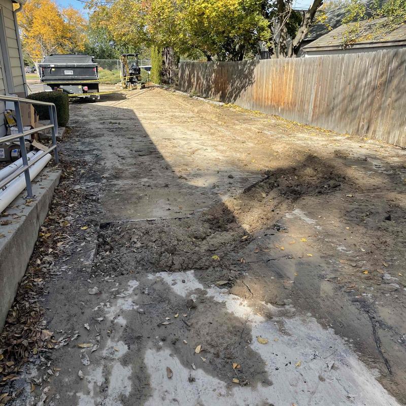 Sewer line excavation and driveway asphalt cut in progress