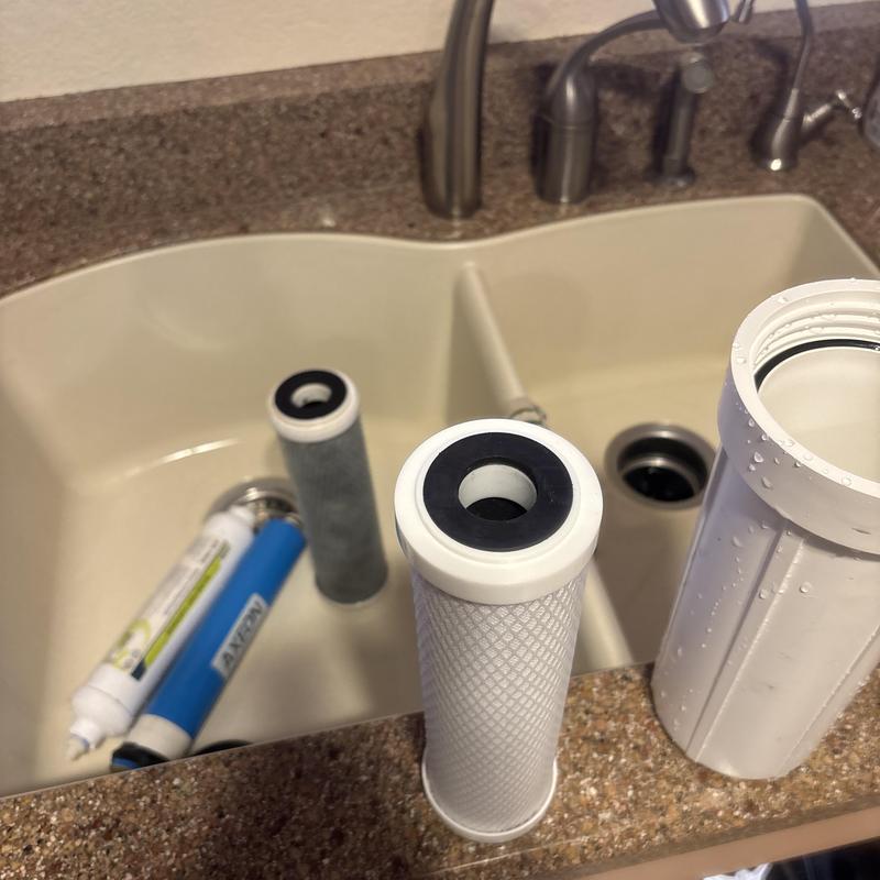 Reverse osmosis filters and membrane replacement parts in sink Reverse osmosis filters and membrane replacement parts in sink