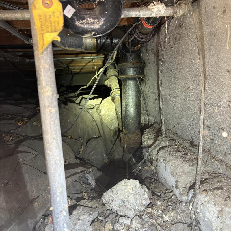 Sewer pipe installation site in crawl space