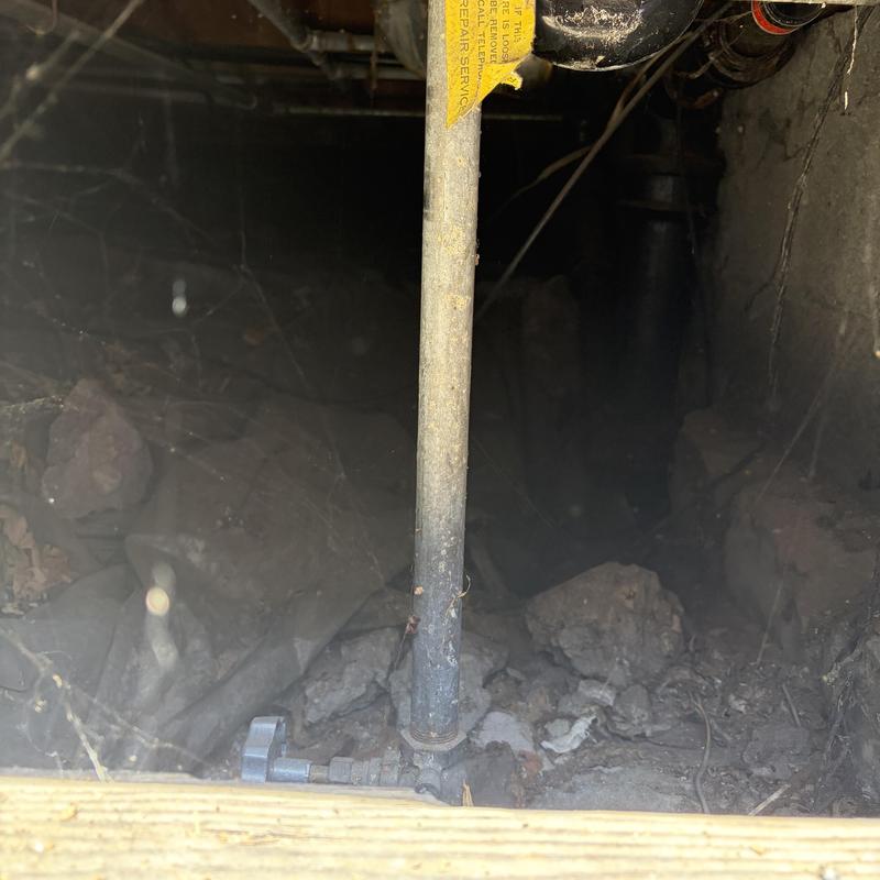 Water main pipe with valve in dirt access hole