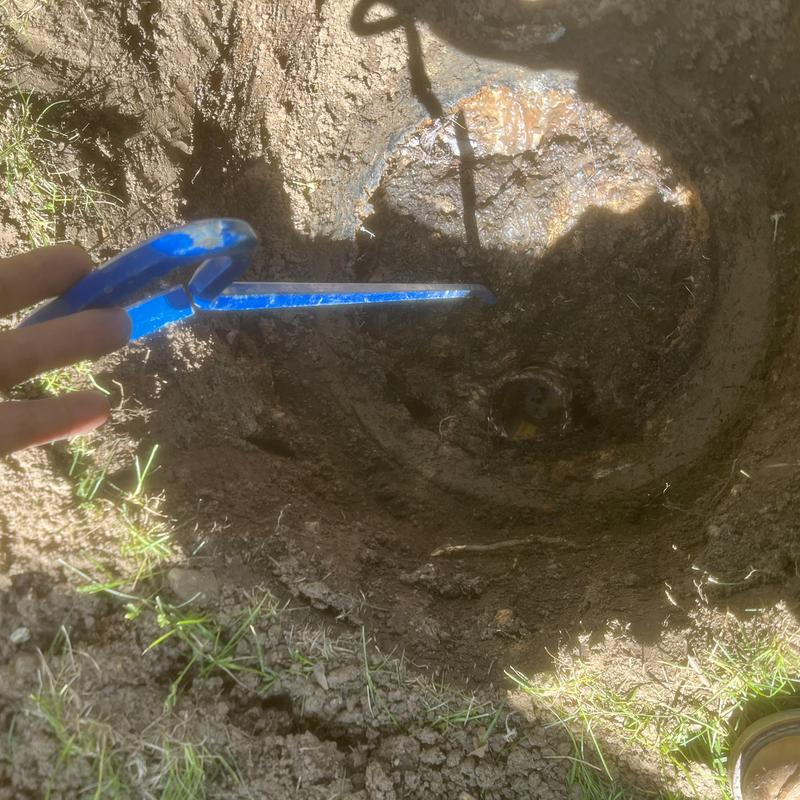 Septic tank inspection probe inside muddy tank hole
