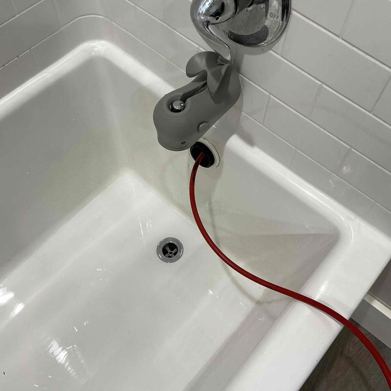 Bathtub drain with flex shaft clearing buildup