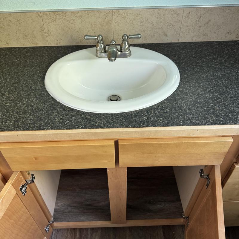 Drop-in lav sink with faucet and open cabinet