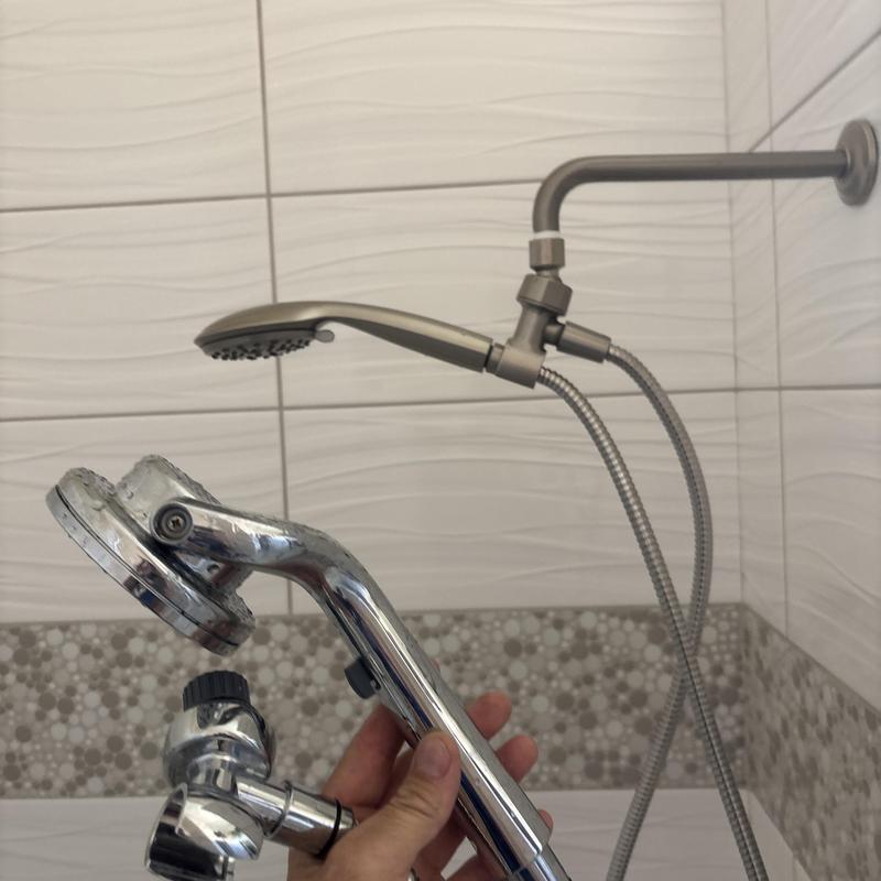 Shower handheld attachment with valve handle in bathroom Shower handheld attachment with valve handle in bathroom