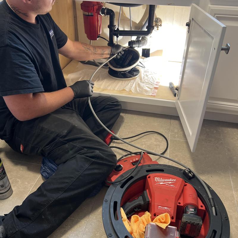 Kitchen drain snake and P-trap removal under sink Kitchen drain snake and P-trap removal under sink