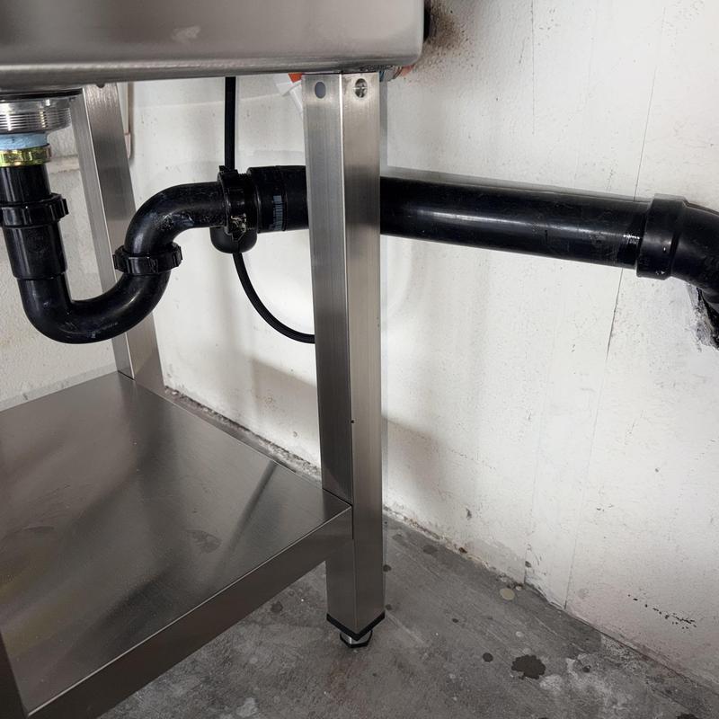 Laundry sink drain line with black PVC piping