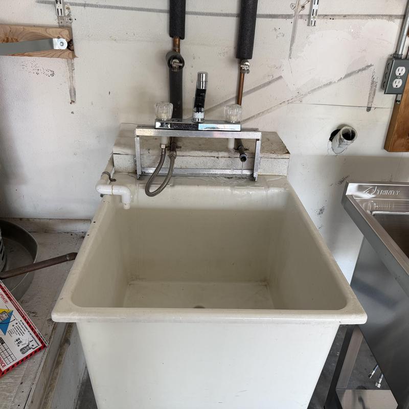 Laundry sink with faucet and plumbing modifications