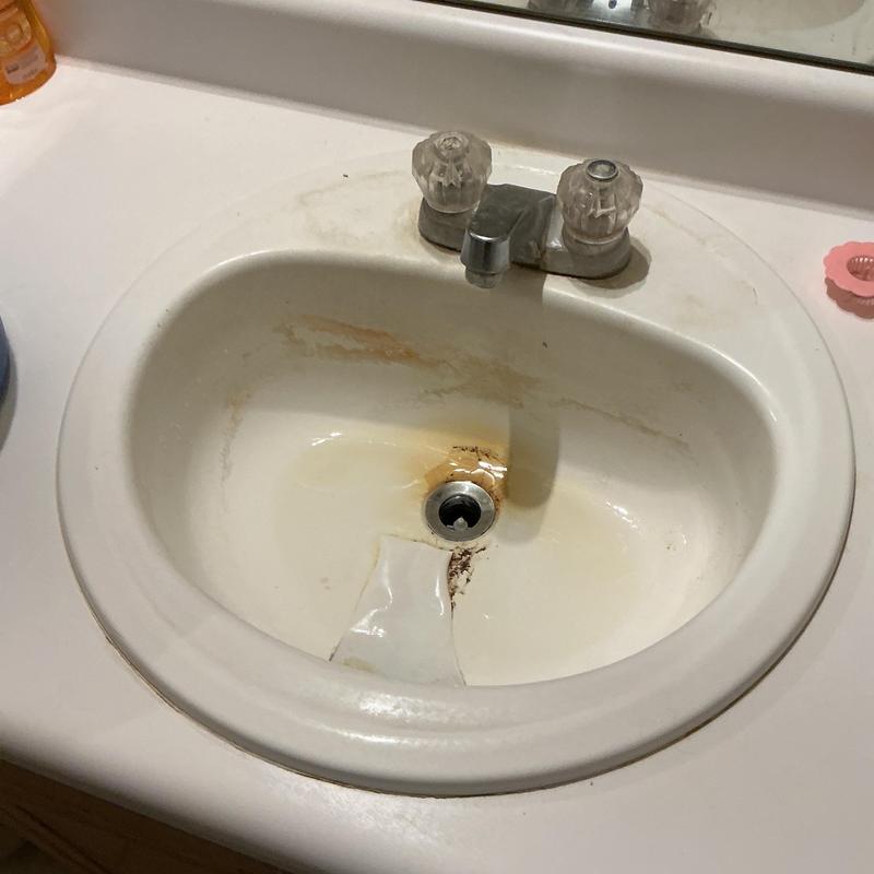 Bathroom sink with cracked basin and rust stains Bathroom sink with cracked basin and rust stains