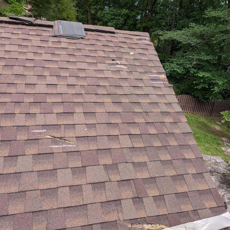 Asphalt shingle roof with storm damage markings Asphalt shingle roof with storm damage markings