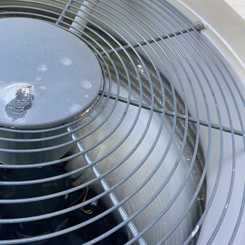 Outdoor air conditioner condenser fan with debris buildup