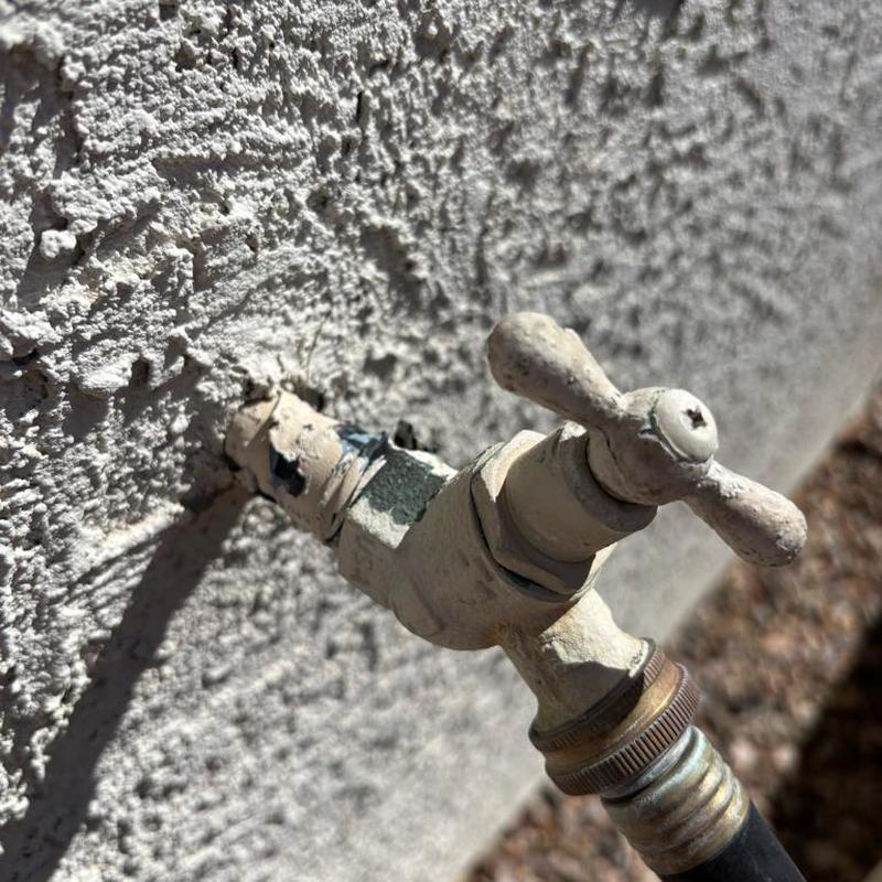 Outdoor hose bib replacement on stucco house wall