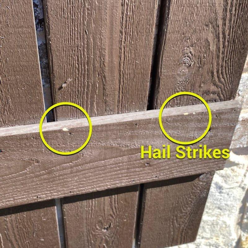 Wooden shutters with hail strike damage close-up