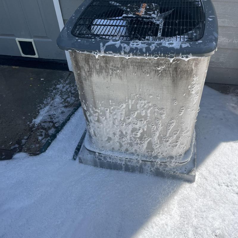 Outdoor air conditioner unit with cleaning foam