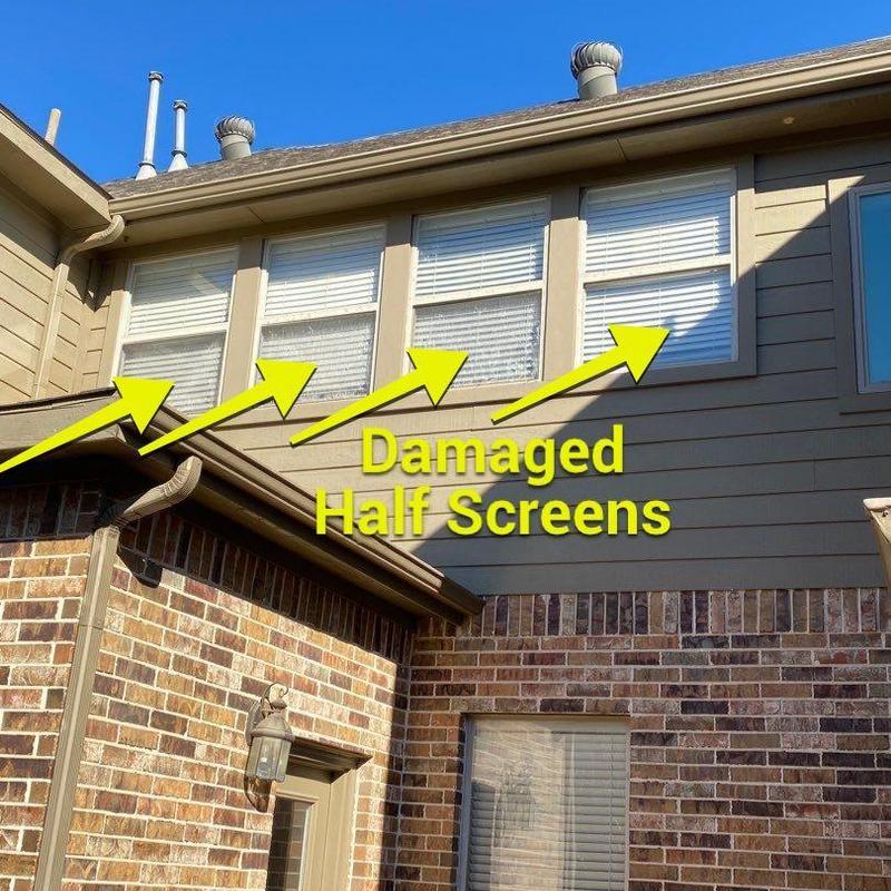 Half window screens with storm damage on house exterior