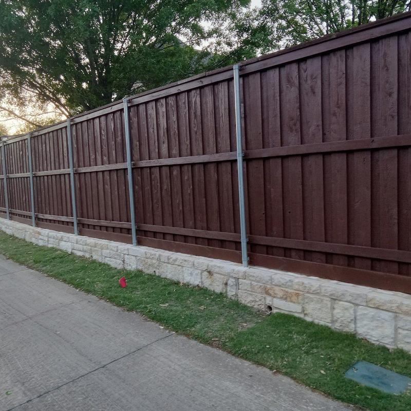 Wood fence with stone base and metal supports