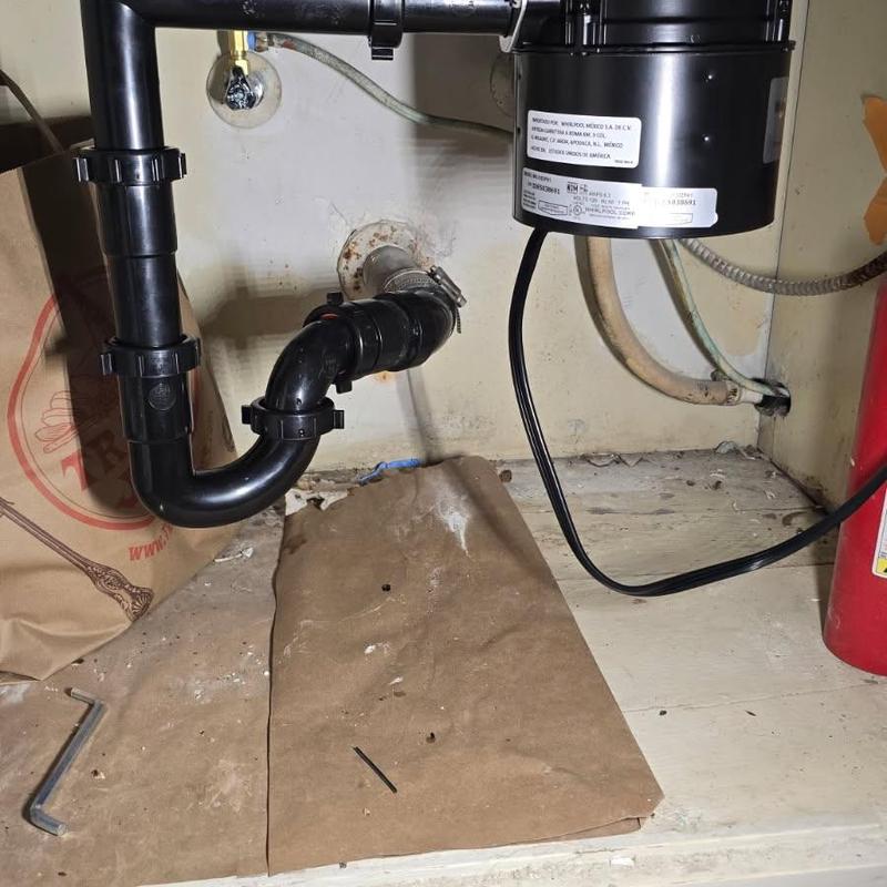 Garbage disposal and P-trap plumbing installation under sink