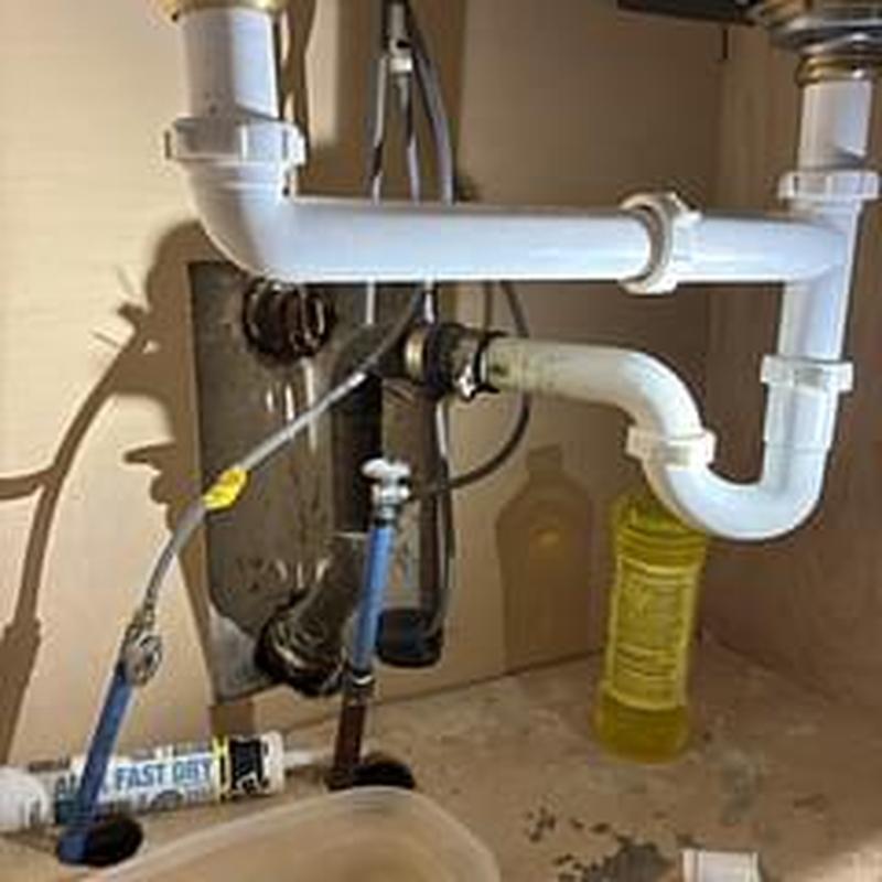 Tubular drain and water heater lines under sink