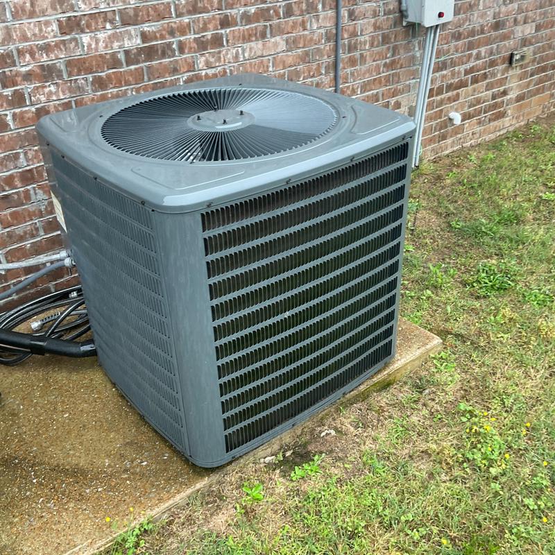 Condenser coil unit exterior with fan grille and wiring