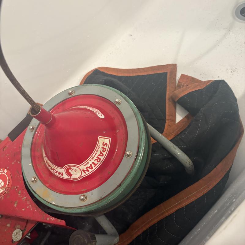 Drain auger head with protective cloth in bathtub Drain auger head with protective cloth in bathtub