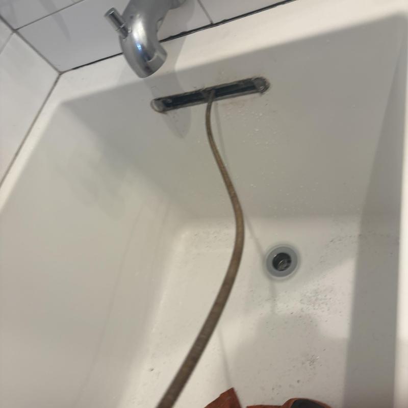 Bathtub drain line with cleaning snake inside Bathtub drain line with cleaning snake inside