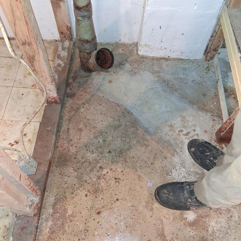Main drain pipe with open end in basement corner