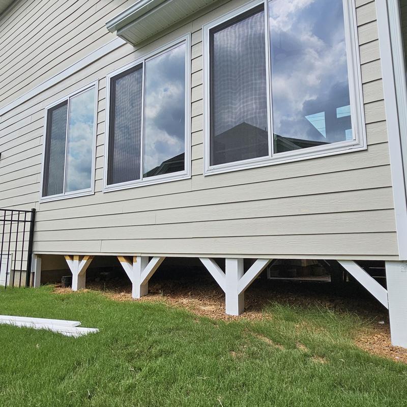 Vinyl windows and beige siding on home addition exterior