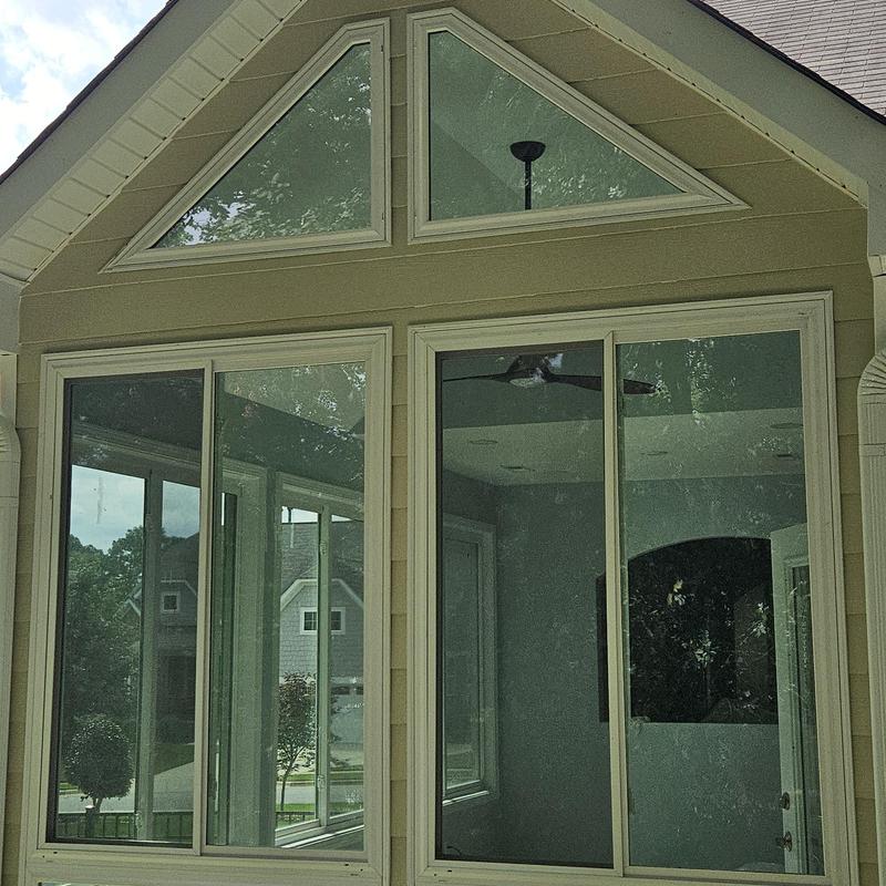 Residential window installation with triangular transom windows