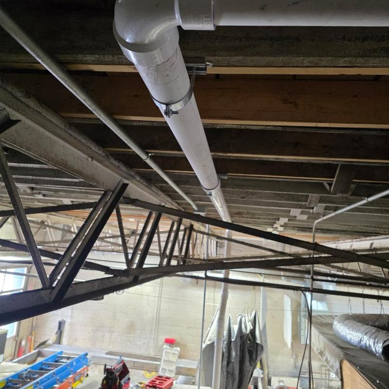 Pilsand interceptor piping installed under ceiling beams