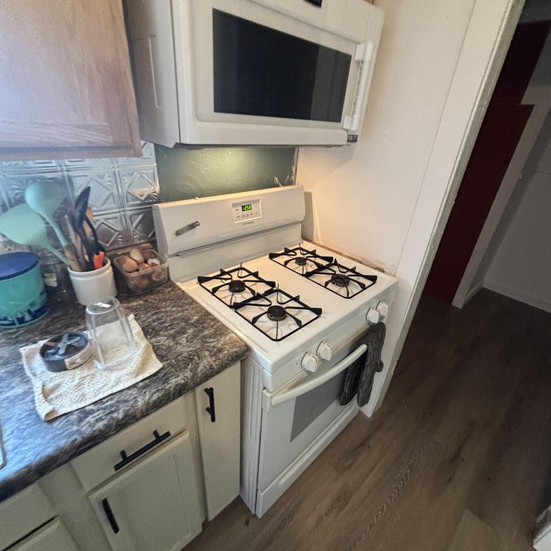 Gas range installation and testing in kitchen corner