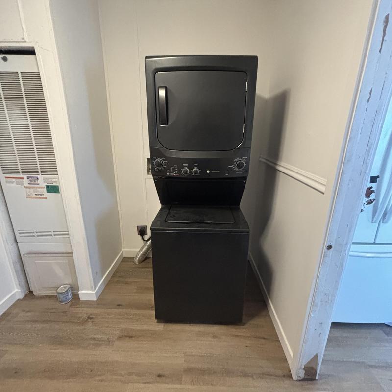 Stacked washer dryer installation in home laundry room