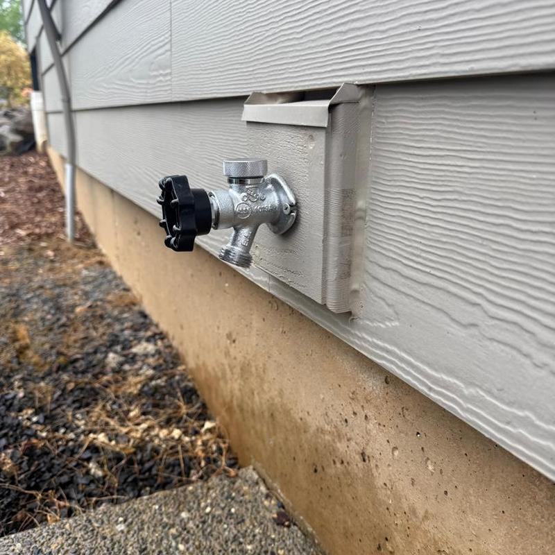 Frost-free hose bib installed on house exterior wall
