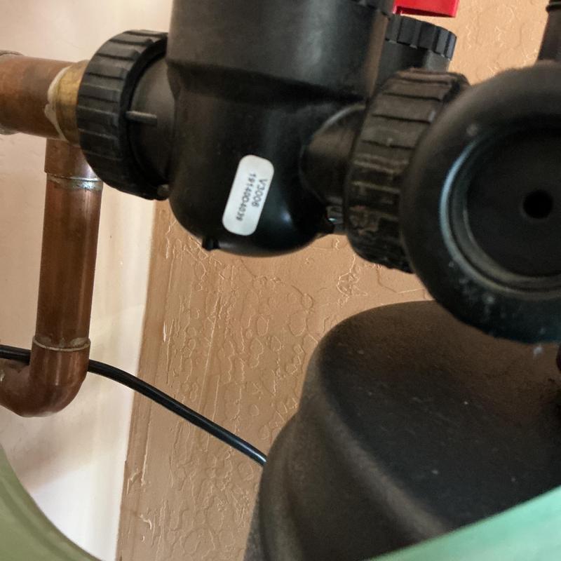 Water softener valve and copper piping close-up Water softener valve and copper piping close-up