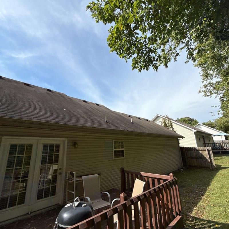 Asphalt shingle roof with visible wear and discoloration