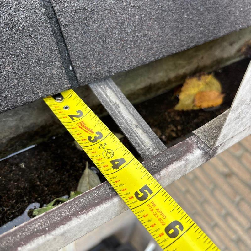 Gutter channel with tape measure showing depth
