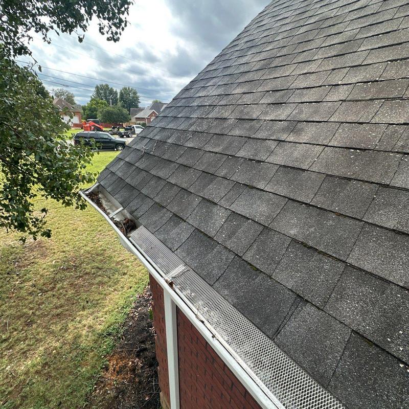 Asphalt shingles roof with hail damage and clogged gutters