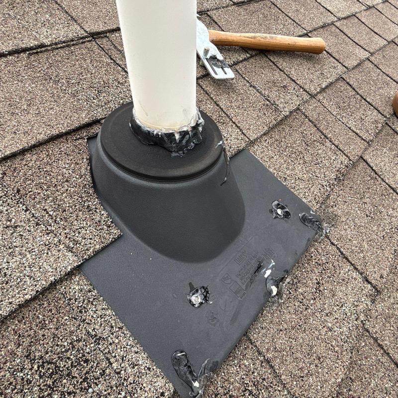 Roof vent pipe flashing with sealant on shingles