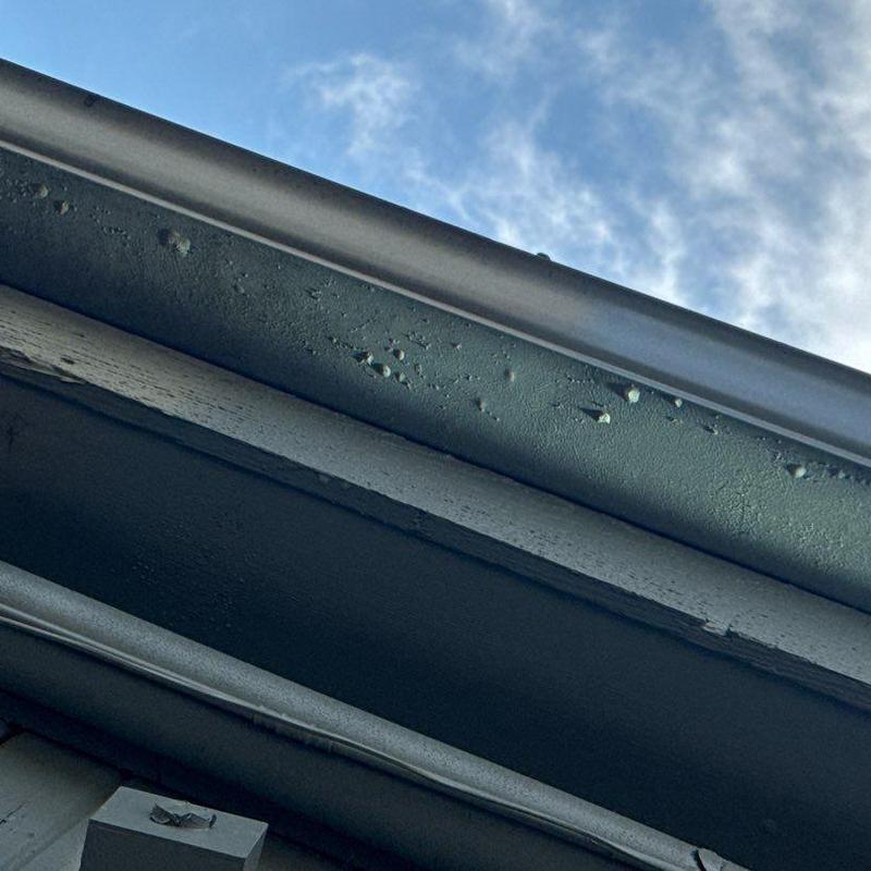 Roofing system hail damage with shingle wear detail