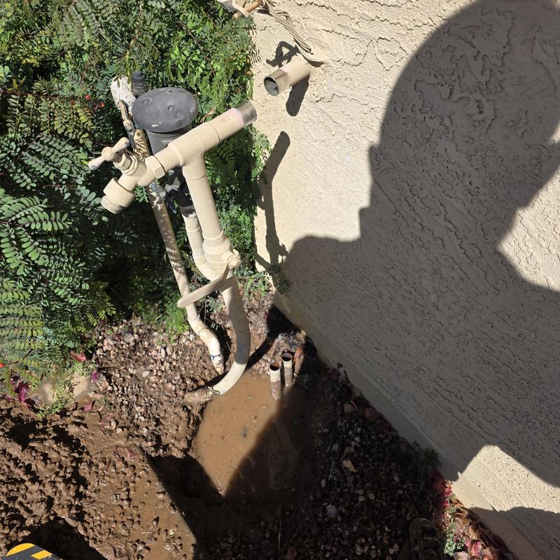 Water service loop with exposed pipes near home wall