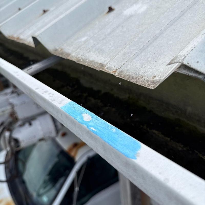 Metal roof edge and gutter with rust spots